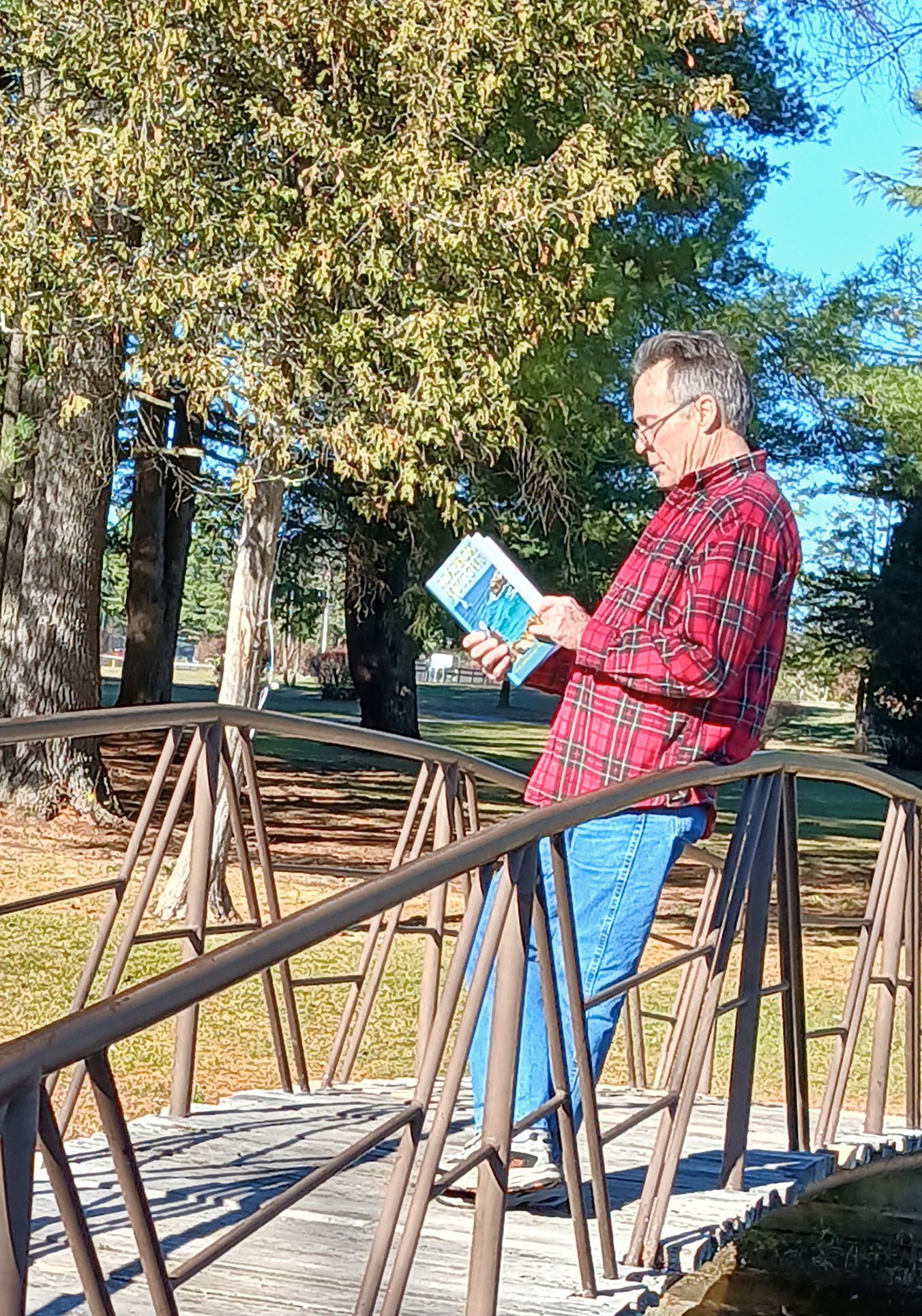 Brad Harrison holding his book and smiling